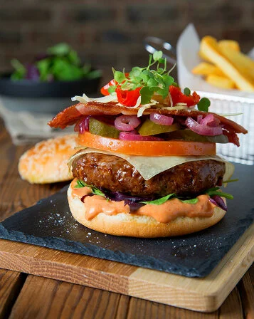Beef and bacon burger styled for Butcher Block Steakhouse. Food styling by Bianca Delides. Photographed by Rikki Hibbert.