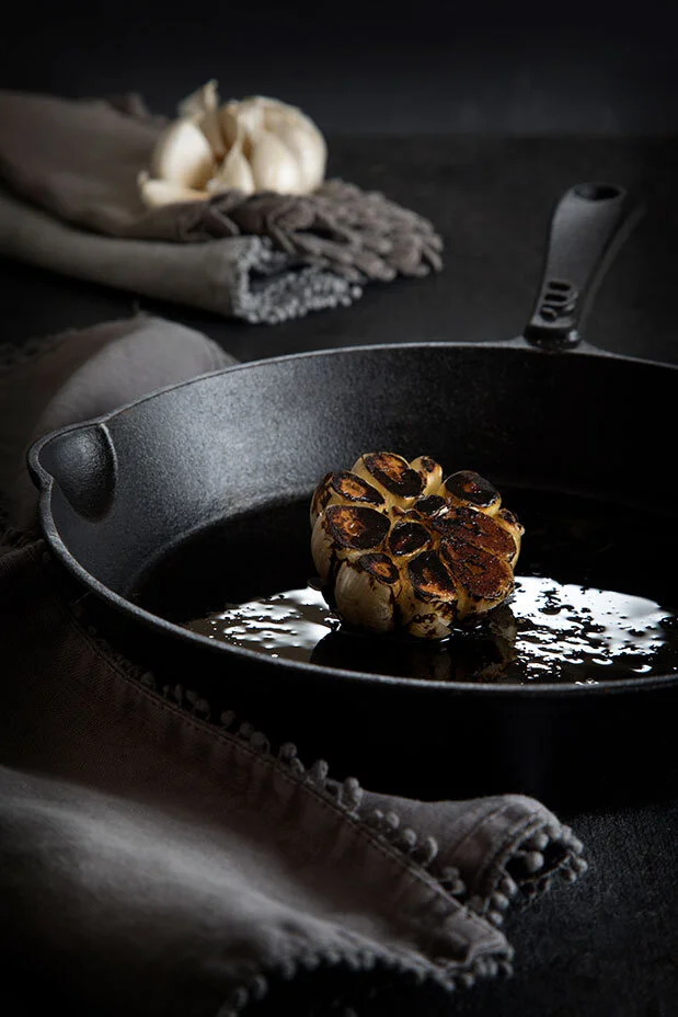 Charred garlic head. Black and white conceptual food shoot. Food styling by Bianca Delides. Photographed by Rikki Hibbert.