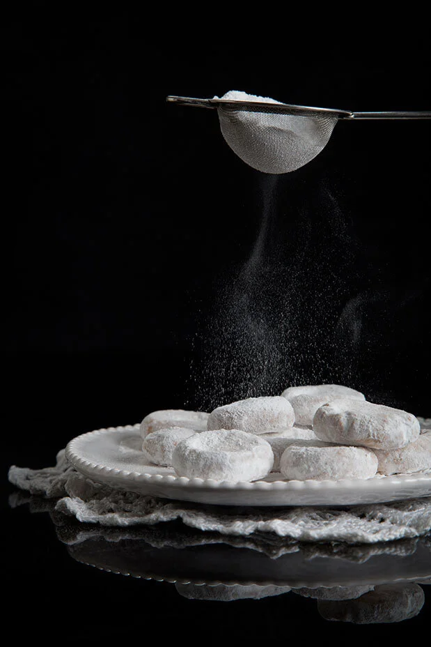 Greek kourabiedes biscuits. Black and white conceptual food shoot. Food styling by Bianca Delides. Photographed by Rikki Hibbert.